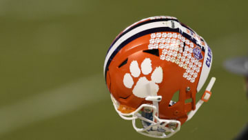 Dec 19, 2020; Charlotte, NC, USA; Clemson Tigers quarterback Trevor Lawrence (16) tosses his helmet to a manager after the ACC Football Championship at Bank of America Stadium. Mandatory Credit: Bob Donnan-USA TODAY Sports