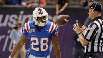 Dec 19, 2015; New Orleans, LA, USA; Louisiana Tech Bulldogs running back Kenneth Dixon (28) flips the football to an official after his third quarter touchdown catch against the Arkansas State Red Wolves in the 2015 New Orleans Bowl at the Mercedes-Benz Superdome. Louisiana Tech won, 47-28. Mandatory Credit: Chuck Cook-USA TODAY Sports