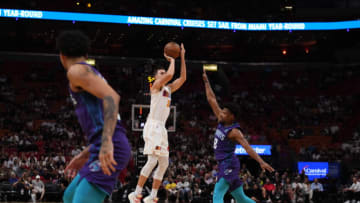Miami Heat guard Duncan Robinson (55) shoots the ball over Charlotte Hornets guard Dennis Smith Jr.(Jasen Vinlove-USA TODAY Sports)