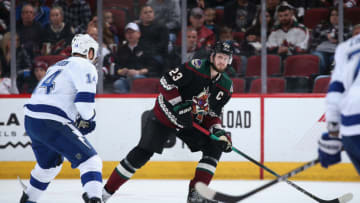GLENDALE, ARIZONA - FEBRUARY 22: Oliver Ekman-Larsson #23 of the Arizona Coyotes skates with the puck against Pat Maroon #14 of the Tampa Bay Lightning during the second period of the NHL game at Gila River Arena on February 22, 2020 in Glendale, Arizona. The Coyotes defeated the Lightning 7-3. (Photo by Christian Petersen/Getty Images)