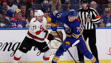 Apr 5, 2022; Buffalo, New York, USA; Buffalo Sabres left wing Victor Olofsson (71) takes the puck from Carolina Hurricanes defenseman Tony DeAngelo (77) during the second period at KeyBank Center. Mandatory Credit: Timothy T. Ludwig-USA TODAY Sports