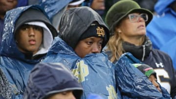 SOUTH BEND, IN - NOVEMBER 18: Fans attempt to stay dry as the Notre Dame Fighting Irish take on the Navy Midshipmen at Notre Dame Stadium on November 18, 2017 in South Bend, Indiana. (Photo by Jonathan Daniel/Getty Images)