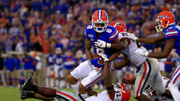 JACKSONVILLE, FLORIDA - NOVEMBER 02: Trevon Grimes #8 of the Florida Gators is tackled by Monty Rice #32 of the Georgia Bulldogs during a game on November 02, 2019 in Jacksonville, Florida. (Photo by Mike Ehrmann/Getty Images)