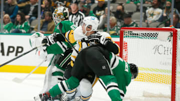 Jan 8, 2022; Dallas, Texas, USA; Pittsburgh Penguins center Sidney Crosby (87) fights for position against Dallas Stars defenseman Miro Heiskanen (4) and goaltender Jake Oettinger (29) in the first period at American Airlines Center. Mandatory Credit: Tim Heitman-USA TODAY Sports