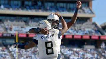 CHAPEL HILL, NC - NOVEMBER 03: Tobias Oliver #8 of the Georgia Tech Yellow Jackets celebrates with teammatges after scoring the go-ahead touchdown against the North Carolina Tar Heels during the fourth quarter of their game at Kenan Stadium on November 3, 2018 in Chapel Hill, North Carolina. Georgia Tech won 38-28. (Photo by Grant Halverson/Getty Images)