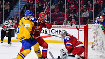 MONTREAL, QC - JANUARY 05: Goaltender Ilya Samsonov #30 of Team Russia makes a stick save while teammate Grigori Dronov #23 battles for position with Lias Andersson #15 of Team Sweden during the 2017 IIHF World Junior Championship bronze medal game at the Bell Centre on January 5, 2017 in Montreal, Quebec, Canada. (Photo by Minas Panagiotakis/Getty Images)