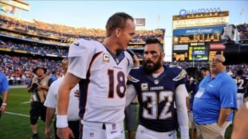 Nov 10, 2013; San Diego, CA, USA; Denver Broncos quarterback Peyton Manning (18) with San Diego Chargers free safety Eric Weddle (32) after the Broncos win at Qualcomm Stadium. Mandatory Credit: Robert Hanashiro-USA TODAY Sports