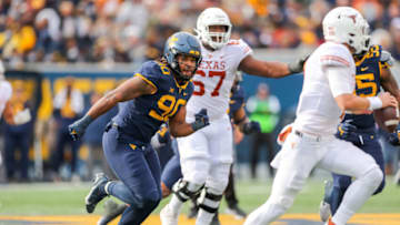 Auburn footballNov 20, 2021; Morgantown, West Virginia, USA; West Virginia Mountaineers defensive lineman Akheem Mesidor (90) chases Texas Longhorns quarterback Hudson Card (1) during the third quarter at Mountaineer Field at Milan Puskar Stadium. Mandatory Credit: Ben Queen-USA TODAY Sports