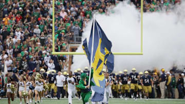 DFS CFB: SOUTH BEND, IN - SEPTEMBER 08: Lead by the mascot against the Notre Dame Fighting Irish cheerleaders, members of the Notre Dame Fighting Irish enter the field before a game agaoinst the Ball State Cardinals at Notre Dame Stadium on September 8, 2018 in South Bend, Indiana. Notre Dame defeated Ball State 24-16. (Photo by Jonathan Daniel/Getty Images)