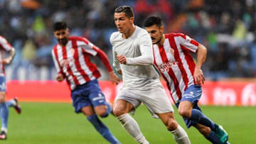 MADRID, SPAIN - NOVEMBER 26: Cristiano Ronaldo of Real Madrid competes for the ball with Sergio Alvarez Diaz of Real Sporting de Gijon during the La Liga match between Real Madrid and Real Sporting de Gijon at the Santiago Bernabeu Stadium on 26 November 2016 in Madrid, Spain. (Photo by Power Sport Images/Getty Images)