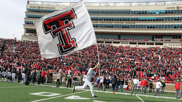 Nov 16, 2019; Lubbock, TX, USA; A Texas Tech Red Raiders cheerleader enters the field before a game against the the Texas Christian Horned Frogs at Jones AT&T Stadium. Mandatory Credit: Michael C. Johnson-USA TODAY Sports