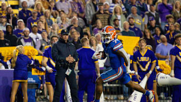 Nov 11, 2023; Baton Rouge, Louisiana, USA; Florida Gators running back Trevor Etienne (7) rushes in for a touchdown against LSU Tigers safety Ryan Yaites (21) during the second half at Tiger Stadium. Mandatory Credit: Stephen Lew-USA TODAY Sports