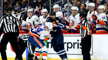 Nov 6, 2021; Winnipeg, Manitoba, CAN; Winnipeg Jets forward Adam Lowry (17) fights New York Islanders defenseman Scott Mayfield (24) during the second period at Canada Life Centre. Mandatory Credit: Terrence Lee-USA TODAY Sports