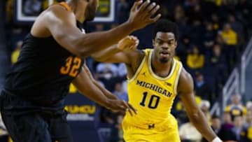 Dec 6, 2016; Ann Arbor, MI, USA; Michigan Wolverines guard Derrick Walton Jr. (10) moves the ball on Texas Longhorns forward Shaquille Cleare (32) in the first half at Crisler Center. Mandatory Credit: Rick Osentoski-USA TODAY Sports
