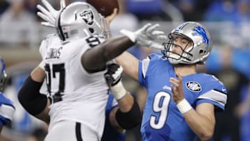 Nov 22, 2015; Detroit, MI, USA; Detroit Lions quarterback Matthew Stafford (9) throws the ball over Oakland Raiders defensive end Mario Jr. Edwards (97) during the second quarter at Ford Field. Mandatory Credit: Raj Mehta-USA TODAY Sports