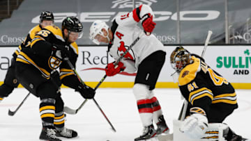 Mar 28, 2021; Boston, Massachusetts, USA; Boston Bruins defenseman Jeremy Lauzon (55) battles New Jersey Devils center Travis Zajac (19) for the puck in front of goaltender Jaroslav Halak (41) during the second period at TD Garden. Mandatory Credit: Winslow Townson-USA TODAY Sports