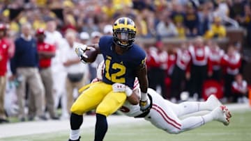 Oct 1, 2016; Ann Arbor, MI, USA; Michigan Wolverines running back Chris Evans (12) rushes at Wisconsin Badgers linebacker T.J. Edwards (53) in the first quarter at Michigan Stadium. Mandatory Credit: Rick Osentoski-USA TODAY Sports