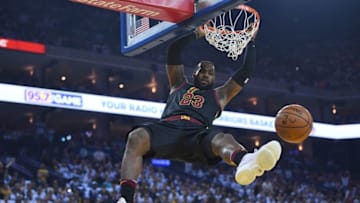 OAKLAND, CA - DECEMBER 25: LeBron James #23 of the Cleveland Cavaliers hangs onto the rim after a slam dunk against the Golden State Warriors during an NBA basketball game at ORACLE Arena on December 25, 2017 in Oakland, California. NOTE TO USER: User expressly acknowledges and agrees that, by downloading and or using this photograph, User is consenting to the terms and conditions of the Getty Images License Agreement. (Photo by Thearon W. Henderson/Getty Images)