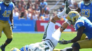 PASADENA, CA - SEPTEMBER 09: Keelan Ewaliko #12 of the Hawaii Warriors runs for a short gain before he is stopped by Jaleel Wadood #4 of the UCLA Bruins in the first half of the game at the Rose Bowl on September 9, 2017 in Pasadena, California. (Photo by Jayne Kamin-Oncea/Getty Images)