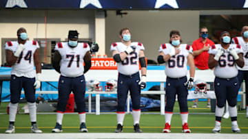 INGLEWOOD, CALIFORNIA - DECEMBER 06: Korey Cunningham #74, Mike Onwenu #71, Joe Thuney #62, David Andrews #60 and Shaq Mason #69 of the New England Patriots stand for the national anthem before the game against the Los Angeles Chargers at SoFi Stadium on December 06, 2020 in Inglewood, California. (Photo by Katelyn Mulcahy/Getty Images)