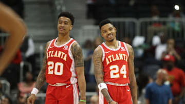 Feb 28, 2018; Atlanta, GA, USA; Atlanta Hawks forward John Collins (20) and guard Kent Bazemore (24) react in the closing minute of their win against the Indiana Pacers at Philips Arena. Mandatory Credit: Jason Getz-USA TODAY Sports