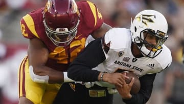 Oct 1, 2016; Los Angeles, CA, USA; Arizona State Sun Devils quarterback Manny Wilkins (right) runs the ball tackled by Southern California Trojans linebacker Uchenna Nwosu (left) during the first half at Los Angeles Memorial Coliseum. Mandatory Credit: Kelvin Kuo-USA TODAY Sports
