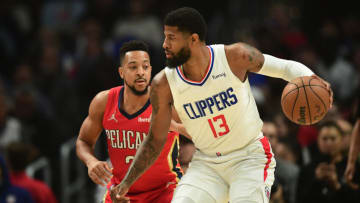 Los Angeles Clippers guard Paul George (13) controls the ball against New Orleans Pelicans guard CJ McCollum Credit: Gary A. Vasquez-USA TODAY Sports