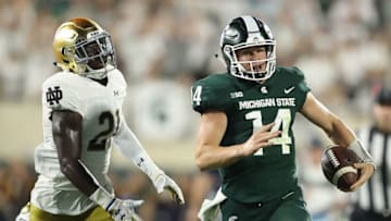 EAST LANSING, MI - SEPTEMBER 23: Brian Lewerke #14 of the Michigan State Spartans runs for a long gain during the first quarter as Jalen Elliott #21 of the Notre Dame Fighting Irish gives chase during the game at Spartan Stadium on September 23, 2017 in East Lansing, Michigan. (Photo by Leon Halip/Getty Images)