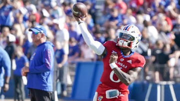 Sep 24, 2022; Lawrence, Kansas, USA; Kansas Jayhawks quarterback Jalon Daniels (6) warms up against the Duke Blue Devils as head coach Lance Leipold watches prior to the game at David Booth Kansas Memorial Stadium. Mandatory Credit: Denny Medley-USA TODAY Sports