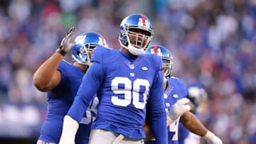 Dec 20, 2015; East Rutherford, NJ, USA; New York Giants defensive end Jason Pierre-Paul (90) reacts after blocking a pass by Carolina Panthers quarterback Cam Newton (not pictured) during the fourth quarter at MetLife Stadium. The Panthers defeated the Giants 38-35. Mandatory Credit: Brad Penner-USA TODAY Sports