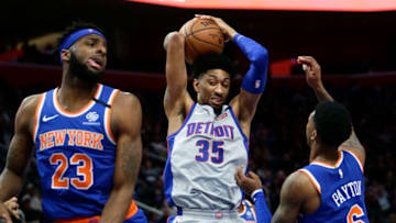 DETROIT, MI - FEBRUARY 8: Christian Wood #35 of the Detroit Pistons grabs a rebound against Mitchell Robinson #23 and Elfrid Payton #6 of the New York Knicks during the first half at Little Caesars Arena on February 8, 2020, in Detroit, Michigan. NOTE TO USER: User expressly acknowledges and agrees that, by downloading and or using this photograph, User is consenting to the terms and conditions of the Getty Images License Agreement. (Photo by Duane Burleson/Getty Images)