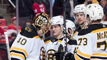 DETROIT, MI - FEBRUARY 06: Torey Krug #47 of the Boston Bruins celebrates with teammates Tuukka Rask #40, Brandon Carlo #25 and Charlie McAvoy #73 following an NHL game against the Detroit Red Wings at Little Caesars Arena on February 6, 2018 in Detroit, Michigan. The Bruins defeated the Wings 3-2. (Photo by Dave Reginek/NHLI via Getty Images)