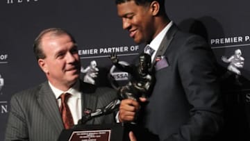 Dec 14, 2013; New York, NY, USA; Florida State Seminoles quarterback and 2013 Heisman Trophy winner Jameis Winston (right) and Seminoles head coach Jimbo Fisher pose with the trophy during a press conference at the New York Marriott Marquis Times Square in New York following the awards ceremony. Mandatory Credit: Brad Penner-USA TODAY Sports