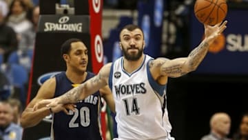 Jan 23, 2016; Minneapolis, MN, USA; Minnesota Timberwolves center Nikola Pekovic (14) tries to hold onto a pass as Memphis Grizzlies center Ryan Hollins (20) defends him in the second quarter at Target Center. Mandatory Credit: Bruce Kluckhohn-USA TODAY Sports