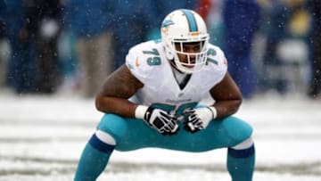 Dec 8, 2013; Pittsburgh, PA, USA; Miami Dolphins defensive end Derrick Shelby (79) prepares to block at the line of scrimmage against the Pittsburgh Steelers during the second quarter at Heinz Field. The Dolphins won 34-28. Mandatory Credit: Charles LeClaire-USA TODAY Sports