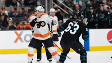 Dec 30, 2021; San Jose, California, USA; Philadelphia Flyers defenseman Nick Seeler (24) and San Jose Sharks left wing Jeffrey Viel (63) prepare to fight during the second period at SAP Center at San Jose. Mandatory Credit: Stan Szeto-USA TODAY Sports