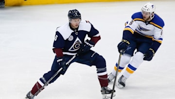 Apr 3, 2016; Denver, CO, USA; Colorado Avalanche defenseman Erik Johnson (6) controls the puck against St. Louis Blues defenseman Joel Edmundson (6) in the second period at the Pepsi Center. Mandatory Credit: Isaiah J. Downing-USA TODAY Sports