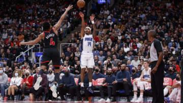 TORONTO, ON - OCTOBER 29: Gary Harris #14 of the Orlando Magic takes a shot over Scottie Barnes #4 of the Toronto Raptors (Photo by Cole Burston/Getty Images)