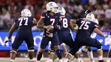 TUCSON, ARIZONA - OCTOBER 08: Quarterback Jayden de Laura #7 of the Arizona Wildcats drops back to pass during the second half of the NCAAF game against the Oregon Ducks at Arizona Stadium on October 08, 2022 in Tucson, Arizona. The Ducks defeated the Wildcats 49-22. (Photo by Christian Petersen/Getty Images)
