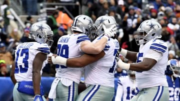 EAST RUTHERFORD, NEW JERSEY - DECEMBER 30: Michael Gallup #13, Blake Jarwin #89, Joe Looney #73, and Cameron Fleming #75 of the Dallas Cowboys react after Looney scored a touchdown during the second quarter of the game against the New York Giants at MetLife Stadium on December 30, 2018 in East Rutherford, New Jersey. (Photo by Sarah Stier/Getty Images)