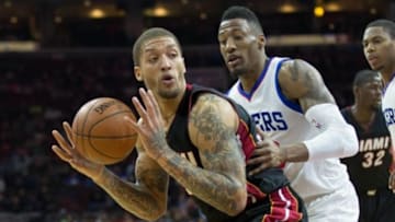 Apr 15, 2015; Philadelphia, PA, USA; Miami Heat forward Michael Beasley (30) looks for an opening past Philadelphia 76ers forward Robert Covington (33) during the second quarter at Wells Fargo Center. Mandatory Credit: Bill Streicher-USA TODAY Sports