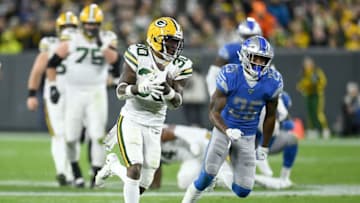 GREEN BAY, WISCONSIN - OCTOBER 14: Running back Jamaal Williams #30 of the Green Bay Packers runs against Will Harris #25 of the Detroit Lions during the game at Lambeau Field on October 14, 2019 in Green Bay, Wisconsin. (Photo by Stacy Revere/Getty Images)