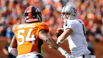 DENVER, CO - OCTOBER 1: Quarterback Derek Carr #4 of the Oakland Raiders looks to pass under pressure by inside linebacker Brandon Marshall #54 of the Denver Broncos in the first half of a game at Sports Authority Field at Mile High on October 1, 2017 in Denver, Colorado. (Photo by Matthew Stockman/Getty Images)