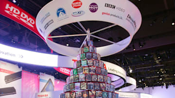 LAS VEGAS - JANUARY 07: An attendee looks at a stack of HD DVDs at the Toshiba booth at the 2008 International Consumer Electronics Show at the Las Vegas Convention Center January 7, 2008 in Las Vegas, Nevada. CES, the world's largest annual consumer technology trade show, runs through January 10 and features 2,700 exhibitors showing off their latest products and services to more than 140,000 attendees. (Photo by Ethan Miller/Getty Images)