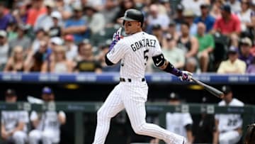 Jun 29, 2016; Denver, CO, USA; Colorado Rockies right fielder Carlos Gonzalez (5) singles in the fourth inning against the Toronto Blue Jays at Coors Field. Mandatory Credit: Ron Chenoy-USA TODAY Sports