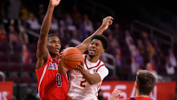 LOS ANGELES, CA - FEBRUARY 20: Tahj Eaddy #2 of the USC Trojans gets past Bennedict Mathurin #0 and Azuolas Tubelis #10 of the Arizona Wildcats in the first half at Galen Center on February 20, 2021 in Los Angeles, California. (Photo by John McCoy/Getty Images)