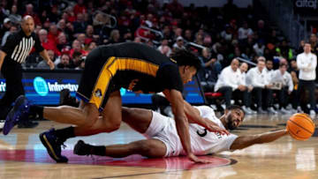 Cincinnati Bearcats guard David DeJulius passes the ball against East Carolina Pirates at Fifth Third Arena. The Enquirer.