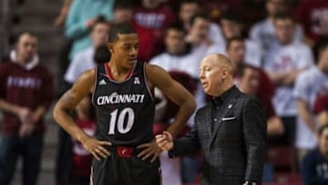 Jan 26, 2014; Philadelphia, PA, USA; Cincinnati Bearcats head coach Mick Cronin talks with guard Troy Caupain (10) during the first half at the Liacouras Center. Cincinnati defeated Temple 80-76. Mandatory Credit: Howard Smith-USA TODAY Sports