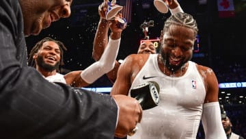 Teammates dump water on Dwyane Wade #3 of the Miami Heat after the game against the Brooklyn Nets (Photo by Sarah Stier/Getty Images)