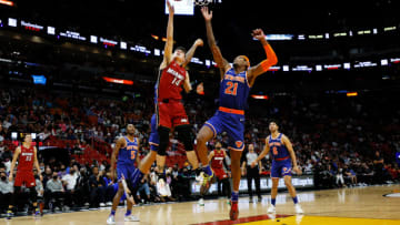 Tyler Herro #14 of the Miami Heat goes up against Obi Toppin #1 and Cam Reddish #21 of the New York Knicks(Photo by Cliff Hawkins/Getty Images)